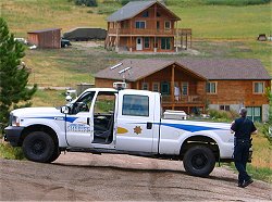 Armed Sheriff's Deputy at intersection of Palisade and Snowtop...