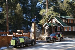 Paul Sterling waves to passersby from atop his "Peace Tree" on March 4th, 2005