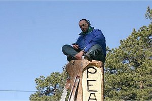 Paul speaking with Senator Steve Johnson from his perch atop tree