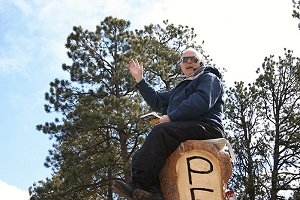 Philip, friend and supporter, waves to passersby on Hwy 34