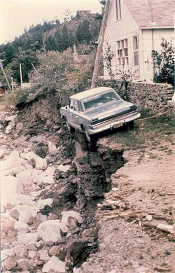 Cars hangs precariously on edge after flood