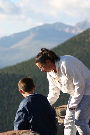 Bridget and Johnny playing with chipmunks at Rainbow Curve on Trail Ridge Road